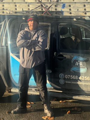 Kelvin, founder of AAA Development, beside the company van in Lancashire